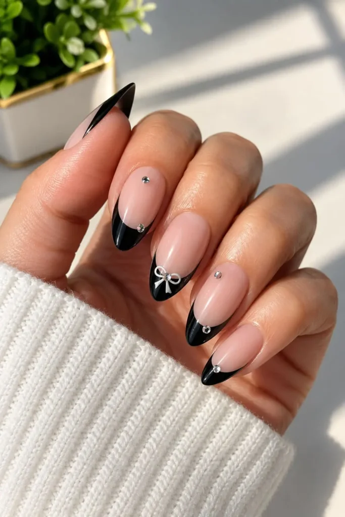 Pink bow nails with classy black French tips and coquette details