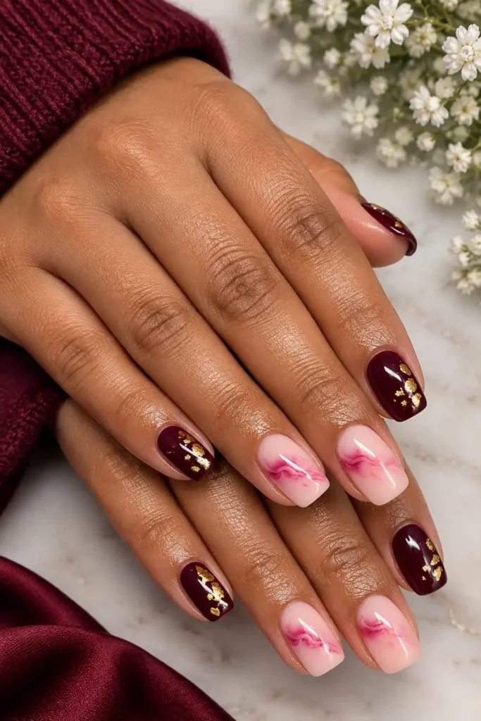 Glamorous short square nails with vivid pink polish, gold flakes, and swirl details