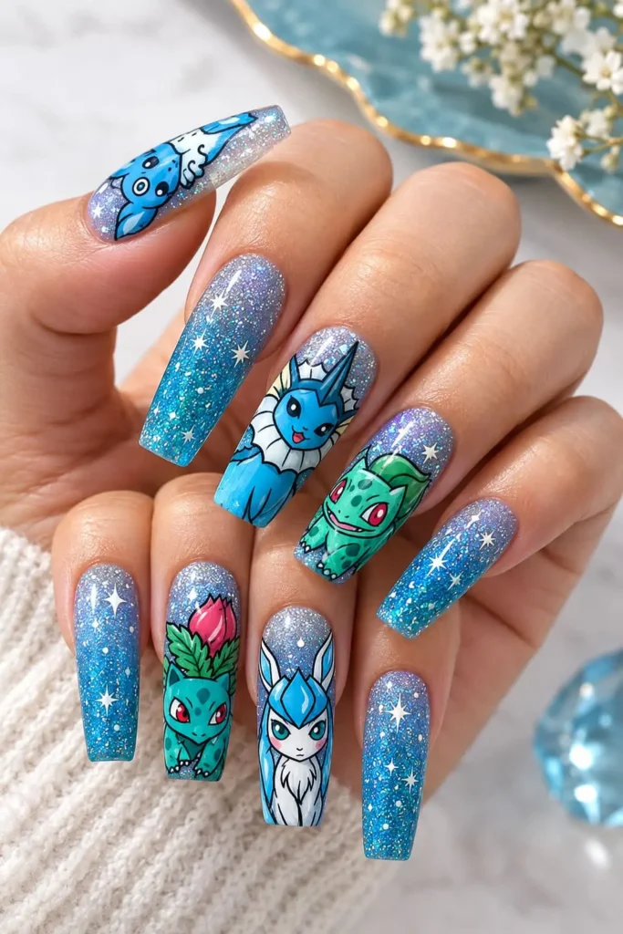 Pokémon nails featuring Eevee, Vaporeon and Bulbasaur on a glittery blue and silver ombré base