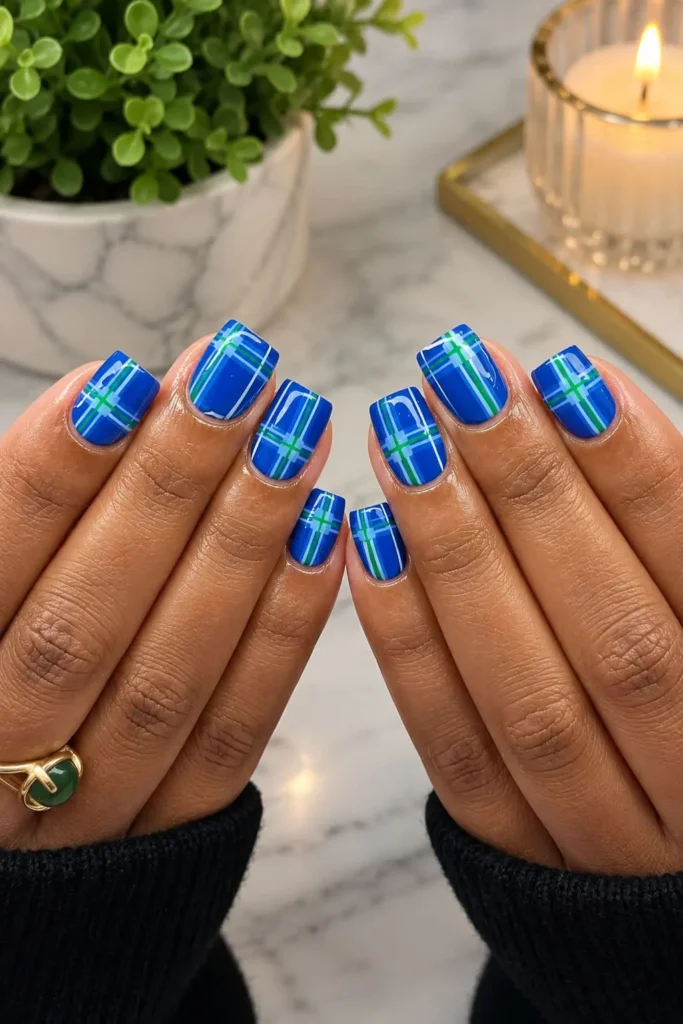 Short square nails with colorful preppy plaid patterns in blue and green