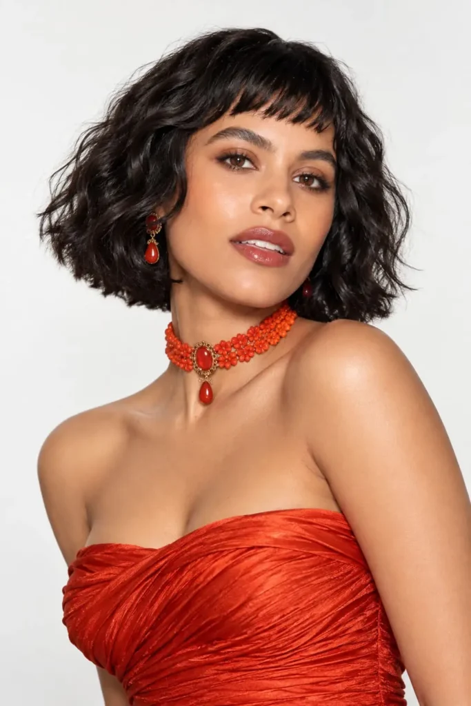 Retro wavy bob haircut with blunt ends, soft structured waves and short baby bangs