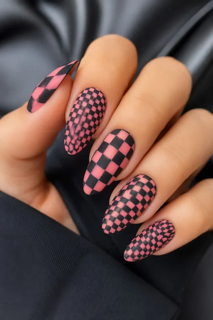 Short square acrylic nails with a modern black and white checkerboard design