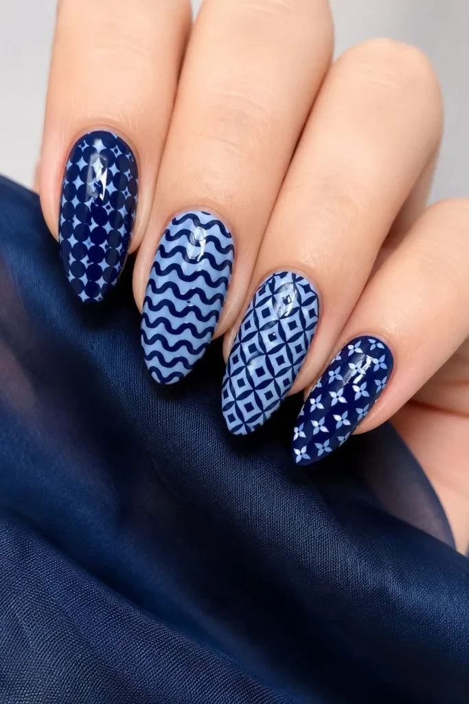 Short acrylic nails featuring a seamless monochromatic blue color gradient