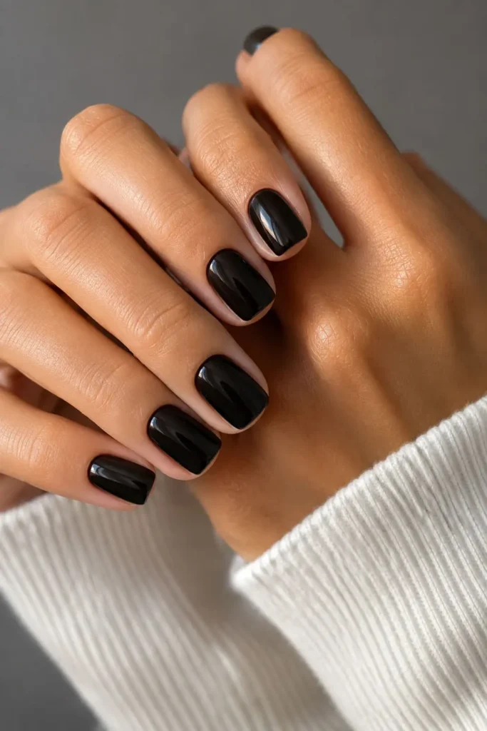 Short square acrylic nails with a sleek high-gloss jet-black finish