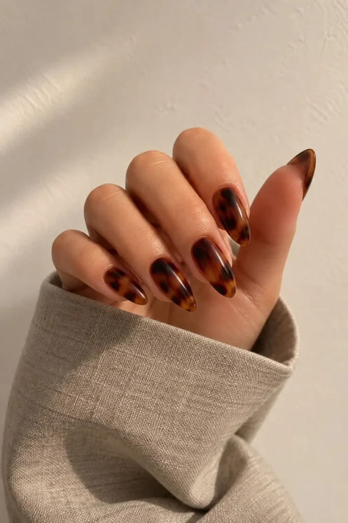 Warm brown tortoiseshell gel nail design with glossy finish